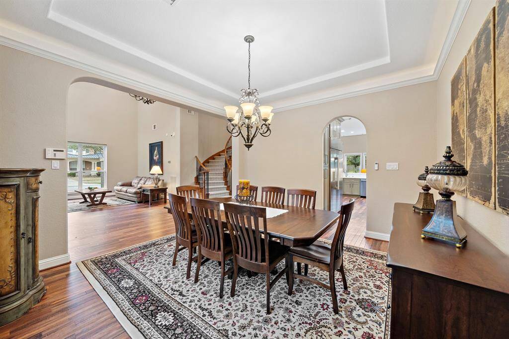An entertainer’s dream, the formal dining room features an open layout and abundant natural light through large windows. The sophisticated and elegant setup offers proximity to the kitchen, making holiday gatherings a breeze.