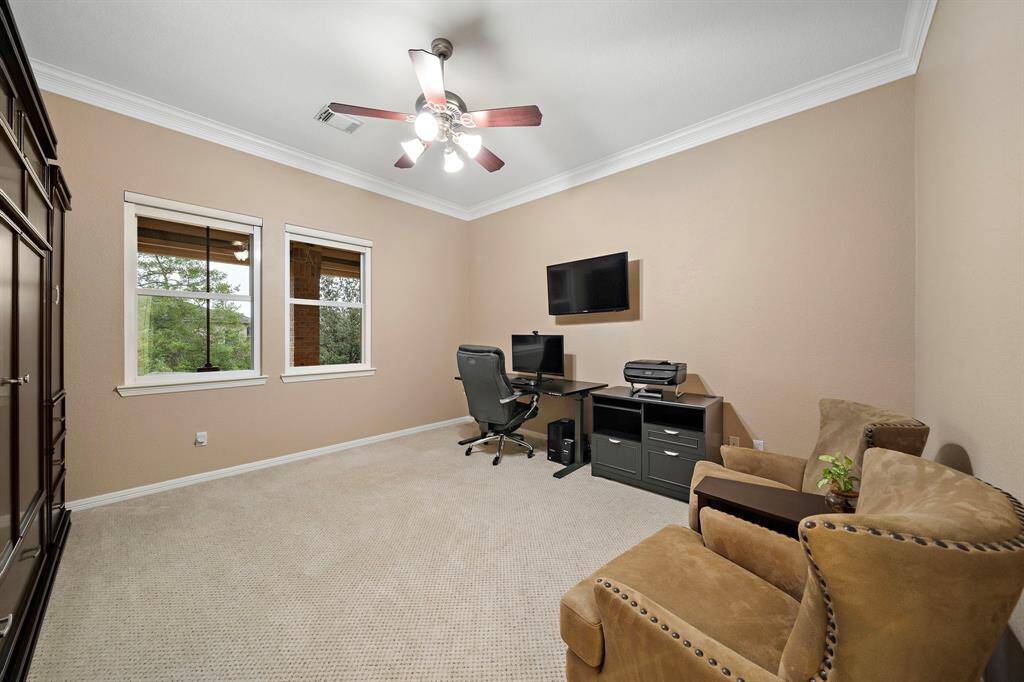 Versatile secondary bedroom features large windows drawing in natural light.. Easily transform this space into a personal office or relaxation area.