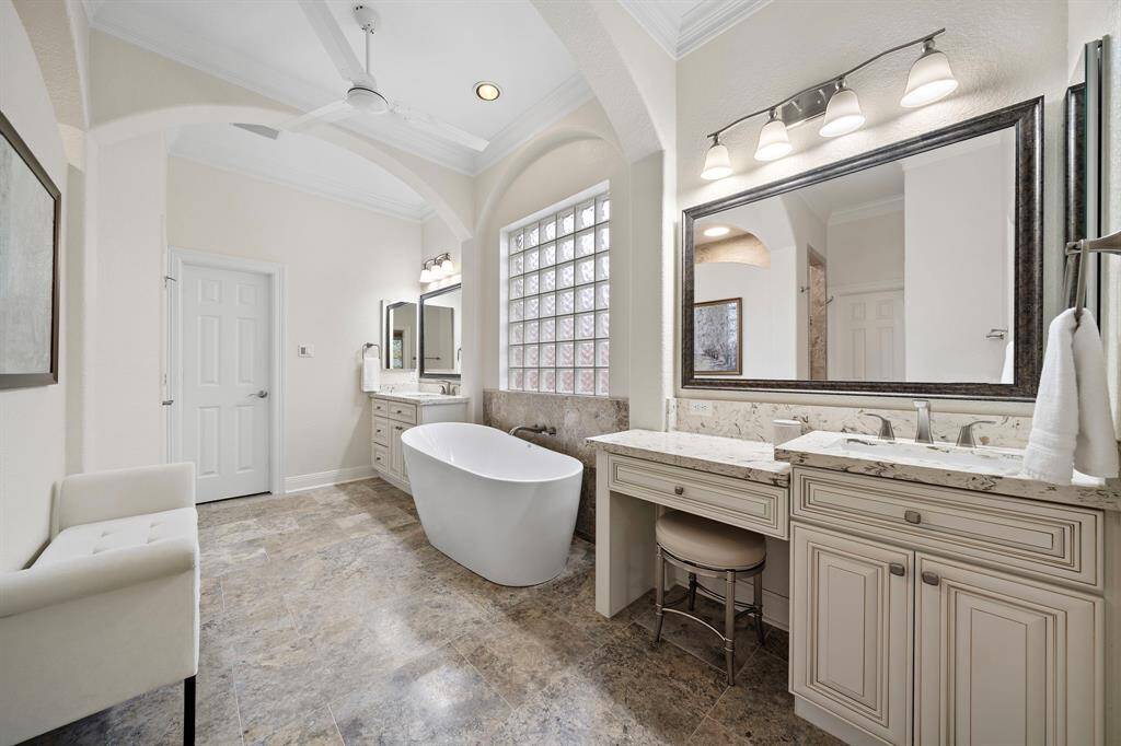 A soaking tub is at the heart of the ensuite bath. Dual vanities are encased with sleek cabinetry and quartz countertops.