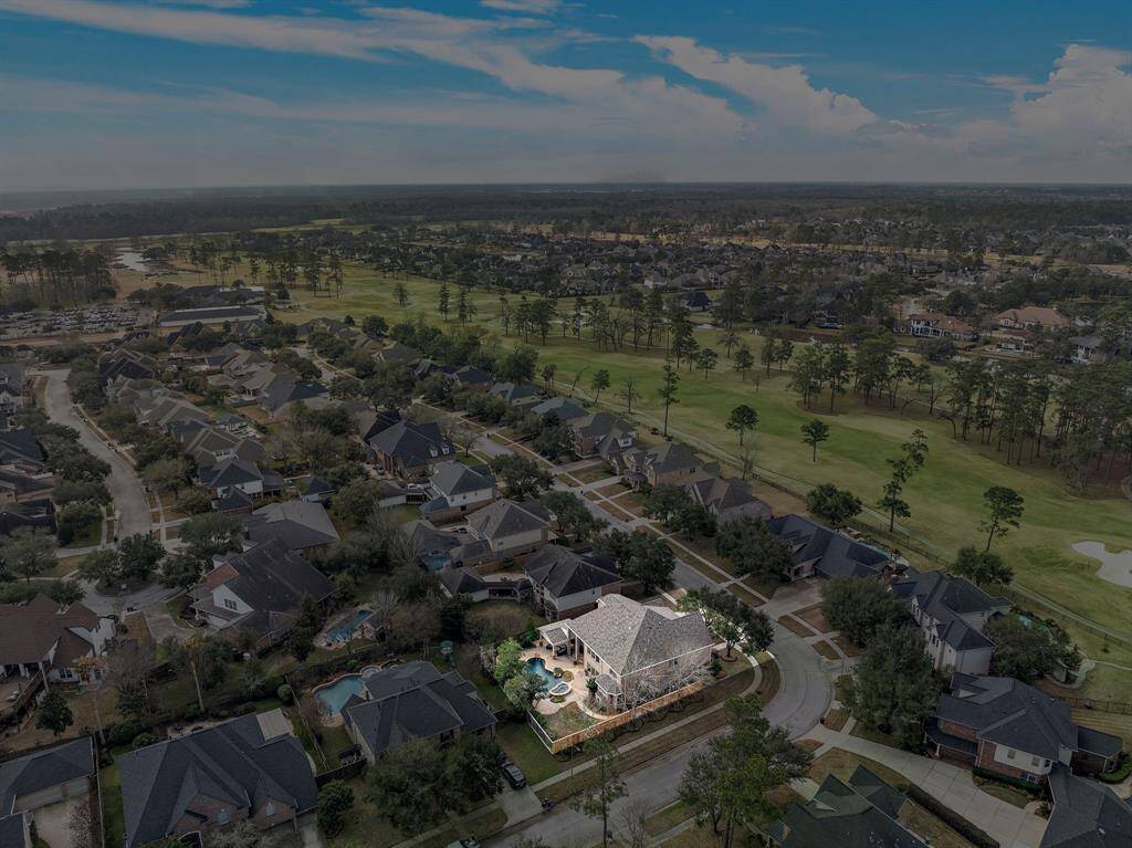 A stunning perspective captures the home’s coveted location within Fall Creek, offering effortless access to recreational amenities, top-rated schools, and major highways for a seamless commute to downtown Houston.