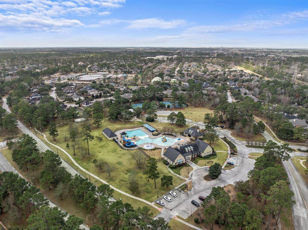 Resort-style amenities include a clubhouse, multiple tennis courts, and a community pool with splash pad. The playground is conveniently located nearby.