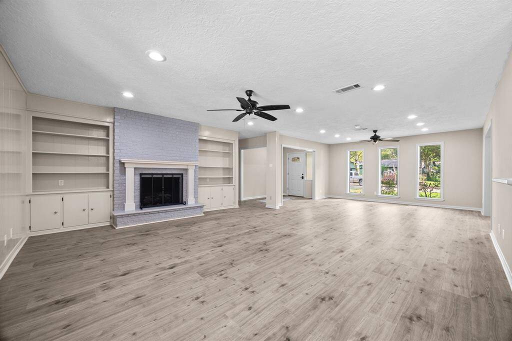 View from the back of the living space to the front of the home lined with double paned windows.