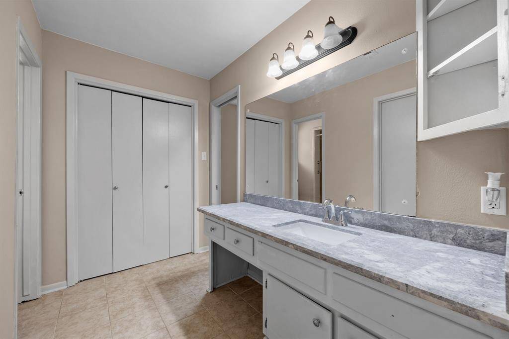 Freshly painted bath with plenty of counter space.