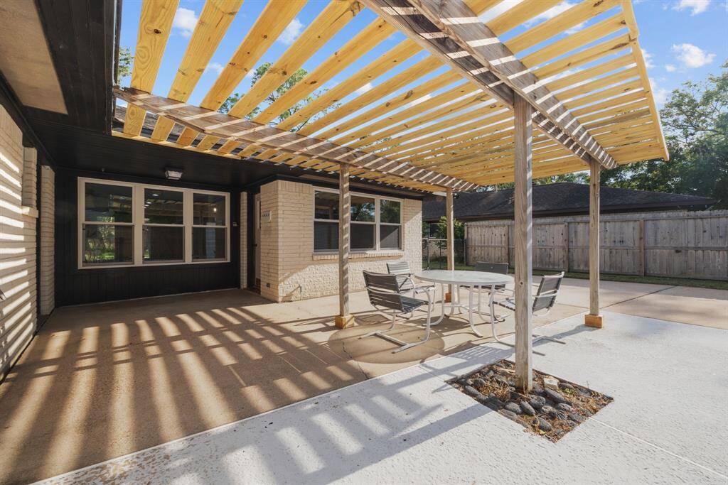 View of patio area from the pool highlighting the double paned windows.