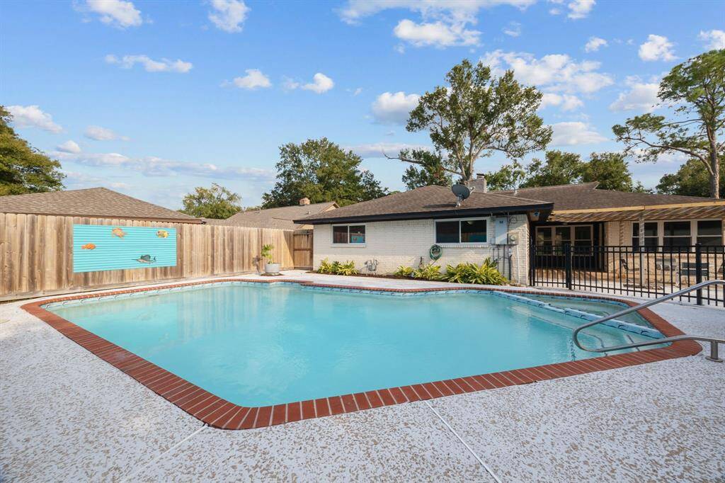 Low maintenance backyard with tasteful landscaping and privacey/safety fence.