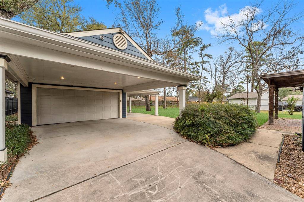 Detached garage with carport, shower, half bathroom and large flex space!