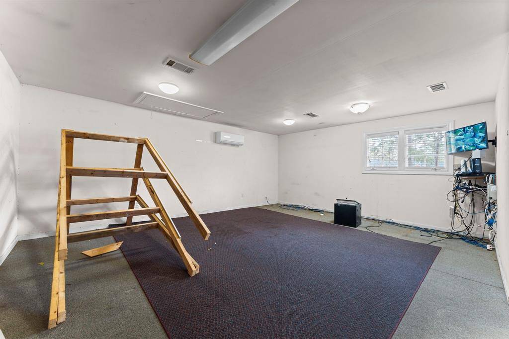 Large flex space inside the garage building that can be used for a multitude of things including office space, storage or work out room.