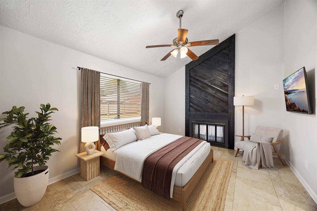 Primary bedroom with fireplace (virtually staged)