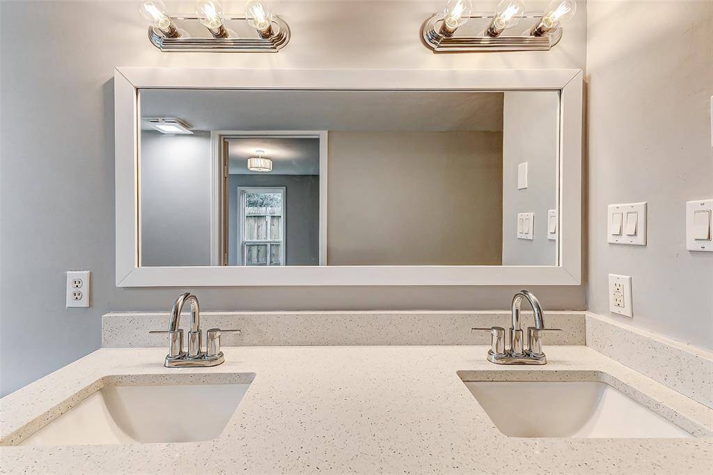 master bath with Brand new cabinets, sisnks, faucets, mirror, soaking tub, and custom shower.