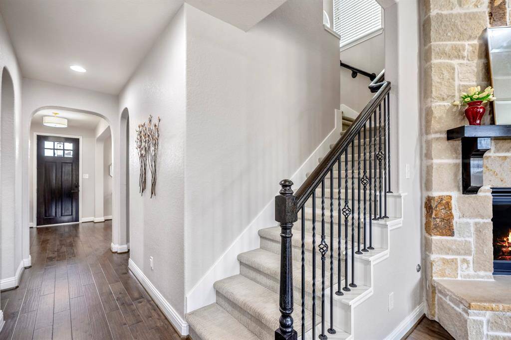 Another view of the inviting entryway leading you upstairs to a spacious game room, media room, and secondary bedrooms & baths—perfect for entertaining and relaxing. A beautiful first impression of a home designed for comfort and fun!