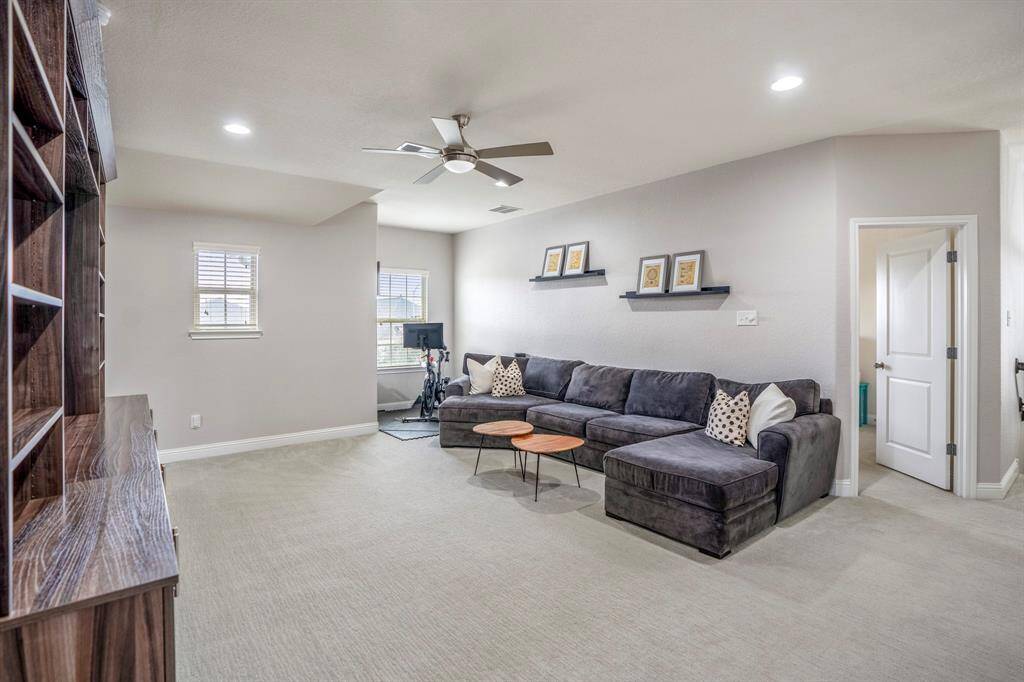 Come and enjoy a day of leisure in the game room! The architectural cutout is the perfect space for a reading nook or study area!