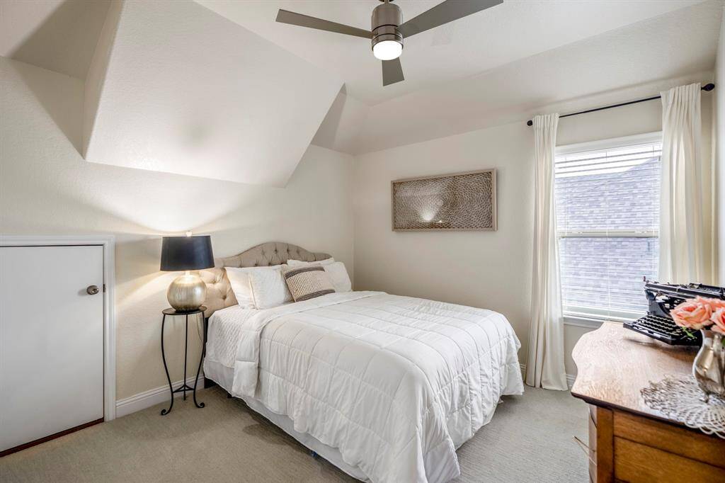 The final of the secondary bedrooms with plush neutral carpet, ceiling fan, natural light, and spacious closet.