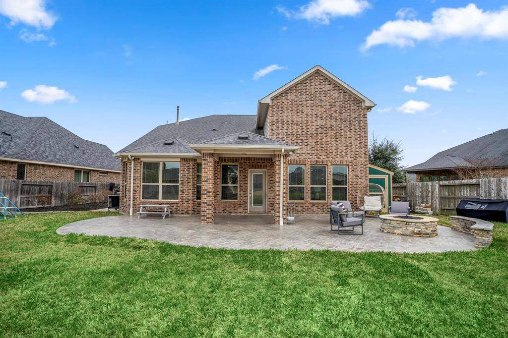 Outdoor living at its finest! This covered patio with extended paved area, a cozy fire pit, and beautiful stonework is perfect for relaxing or entertaining year-round. Just add good company and enjoy!
