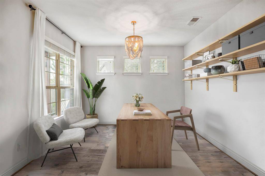 Work in style! This chic home office features wood floors, space for cozy seating or a reading nook, and plenty of natural light—perfect for productivity and inspiration. *This room has been virtually staged