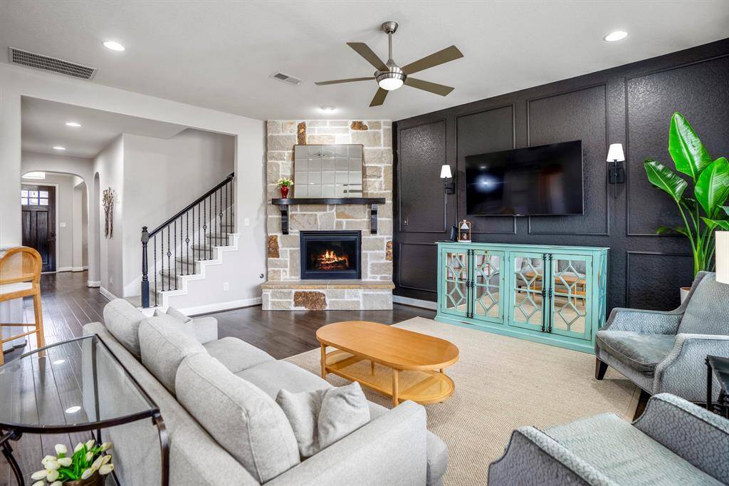 You'll love cozying up by the fireplace, complete with a sleek wood mantle, stone surround, and a decorative place for art. This room can fit any size tv making it great for the next big game or movie night.