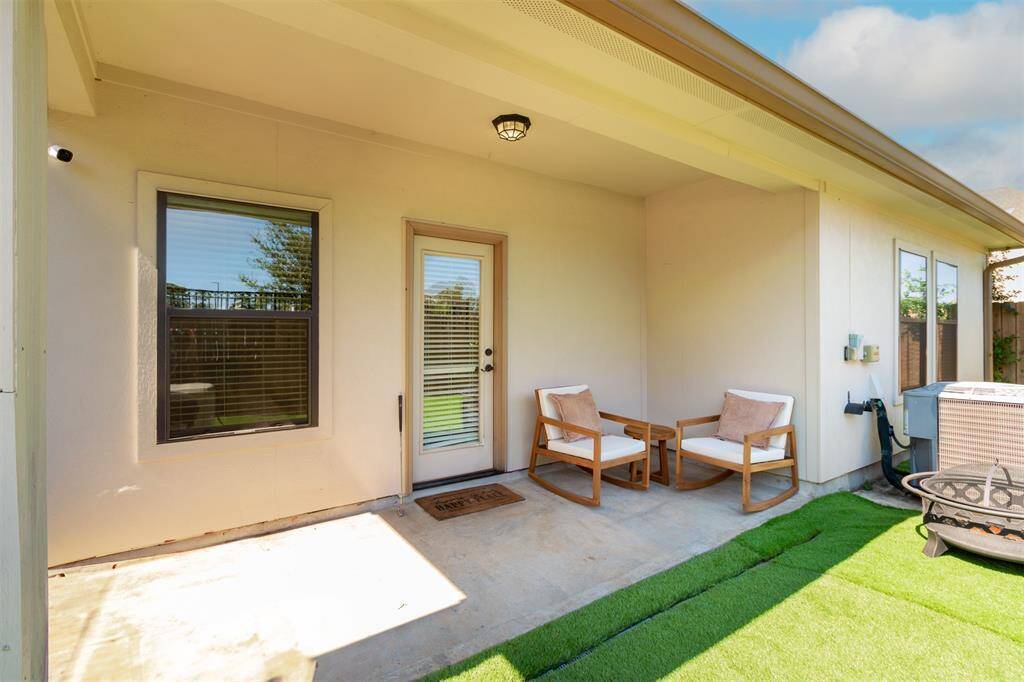 Enjoy the inviting covered patio and lush turf for perfect outdoor relaxation.