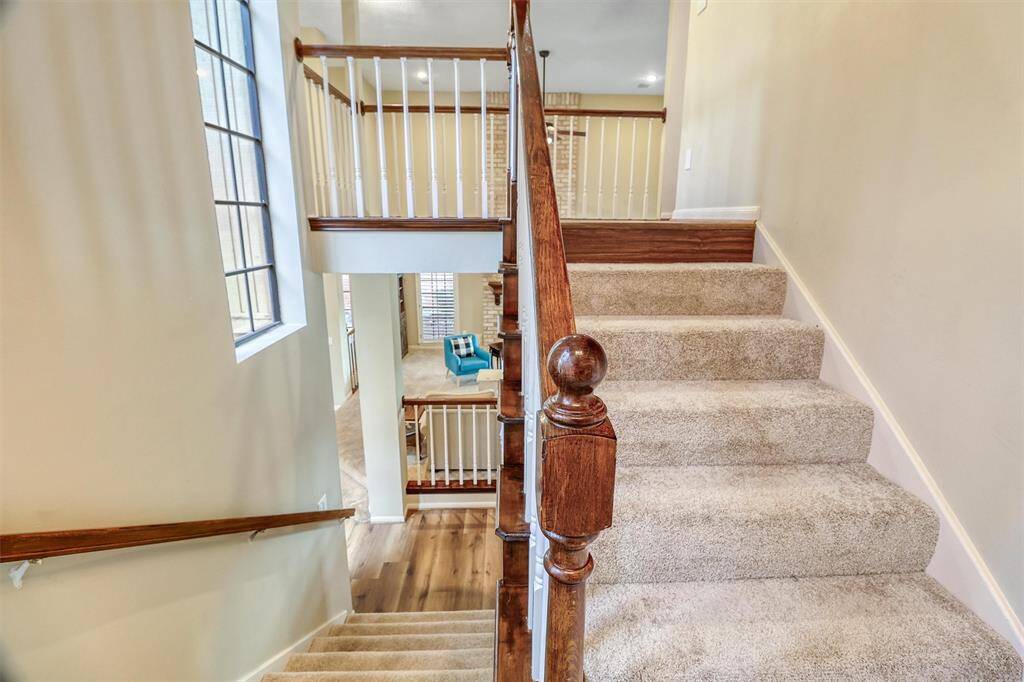 View standing on stairway landing to second floor again featuring large windows for lots of natural light.