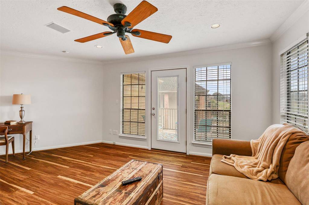 Another view of second floor living area and doorway to outside balcony.