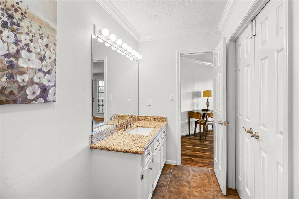 Another view of upstairs full bathroom showing double door entrance to upstairs secondary bedroom.