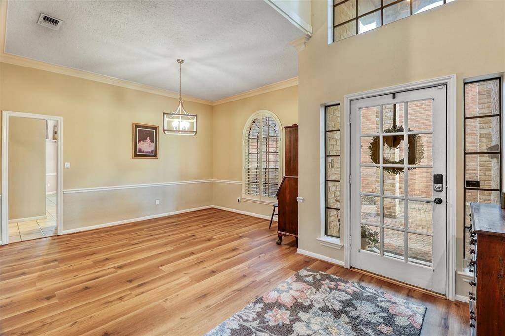 Welcome guests into soaring 2-story foyer open to dining and family rooms.