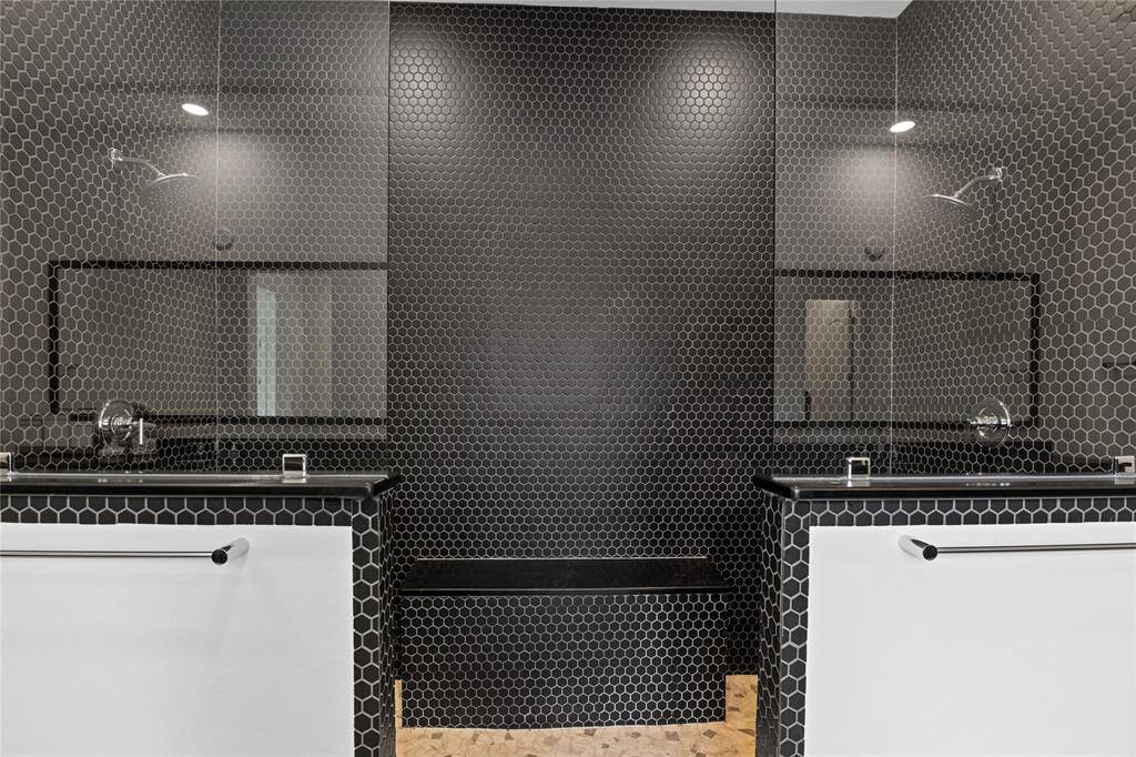 Luxurious primary bathroom featuring double showers for a spa-like experience.