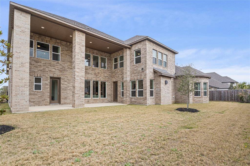 Spacious back porch perfect for relaxing or entertaining, overlooking a generous yard.