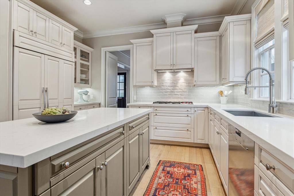 Quartz countertops were added with a complimenting subway tile backsplash.  Tons of storage.