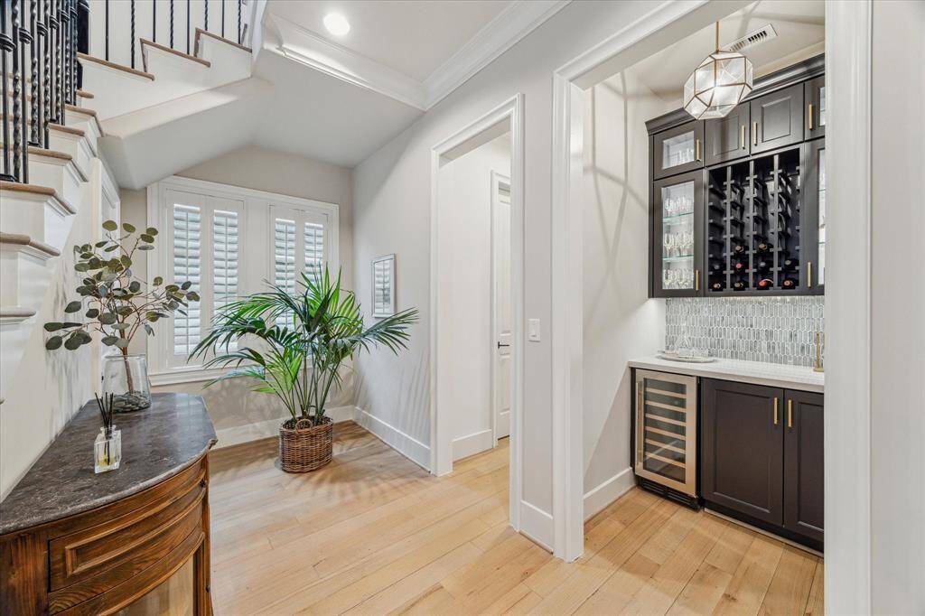 DRYBAR.   This is a cleverly renovated hallway closet (which is actually the elevator shaft) and includes wine bottle storage, cabinet storage and 34-bottle wine cooler.  Quartzite countertops and new pendant light.    Discreet luxury, and also functional.
