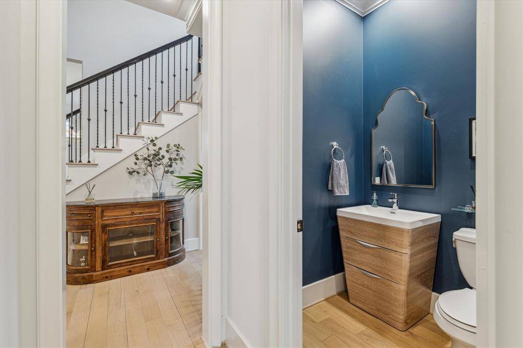 POWDER ROOM.  Located in a small hallway between the study and stairs so it's cleverly tucked away. New vanity and faucet installed, complimented by a Pottery Barn mirror.