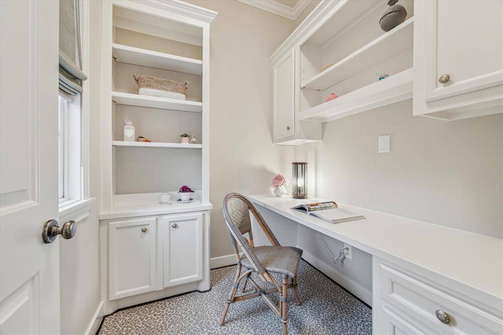 STUDY NOOK.   A small but highly functional office space located off the primary bedroom.  Ideal if two people are working from home.  New cabinet hardware and updated pendant lighting.