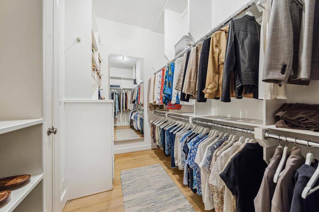 The second and larger of the two primary bedroom walk in closets with build in storage.   Track lighting installed for enhanced illumination.
