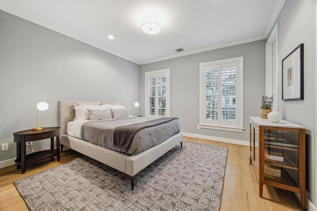 BEDROOM TWO.  Located at the front of the home and is the ideal guest room as it has it's own bathroom and walk in closet.  Plantation shutters installed.