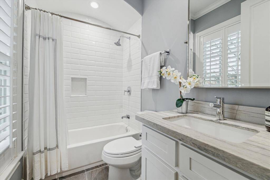 BATHROOM TWO.   Updated with quartzite countertops, new sink, bathtub, faucets, shower tile, floor tile and hardware.