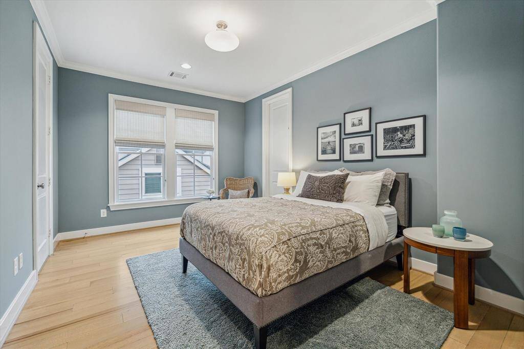 BEDROOM THREE.    Wanting to add some variation to the home's color palette, the current owners decorated this room in a gorgeous blue/gray.  Large walk in closet to the left of the bed.