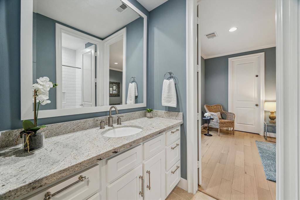 BATHROOM THREE.  The blue/gray theme continues into the shared Jack and Jill bathroom which connects bedrooms three and four.  Updated with new shower tile and tub, new faucets and hardware.