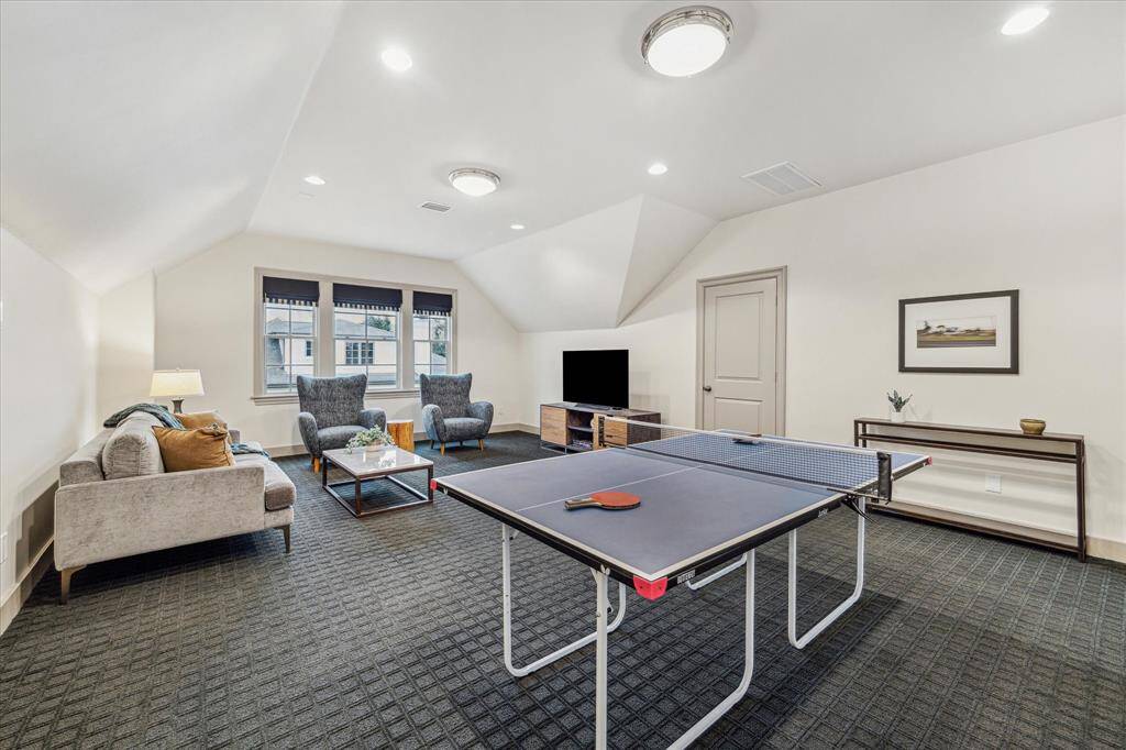 GAMEROOM/BEDROOM FIVE.  An amazing multi purpose space on the third floor, the current owners enjoy watching movies up here.  Would make an idea guest suite, nanny suite, gameroom or home gym.