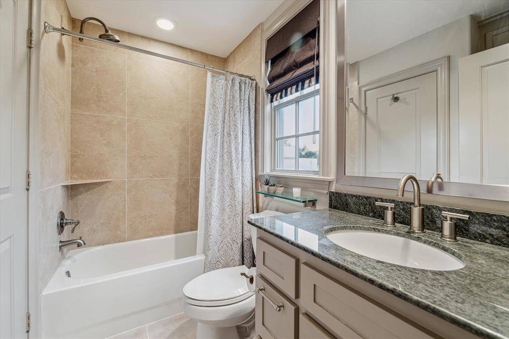 BATHROOM FOUR.  Serves the third floor.  Also has additional storage just behind the photographer.