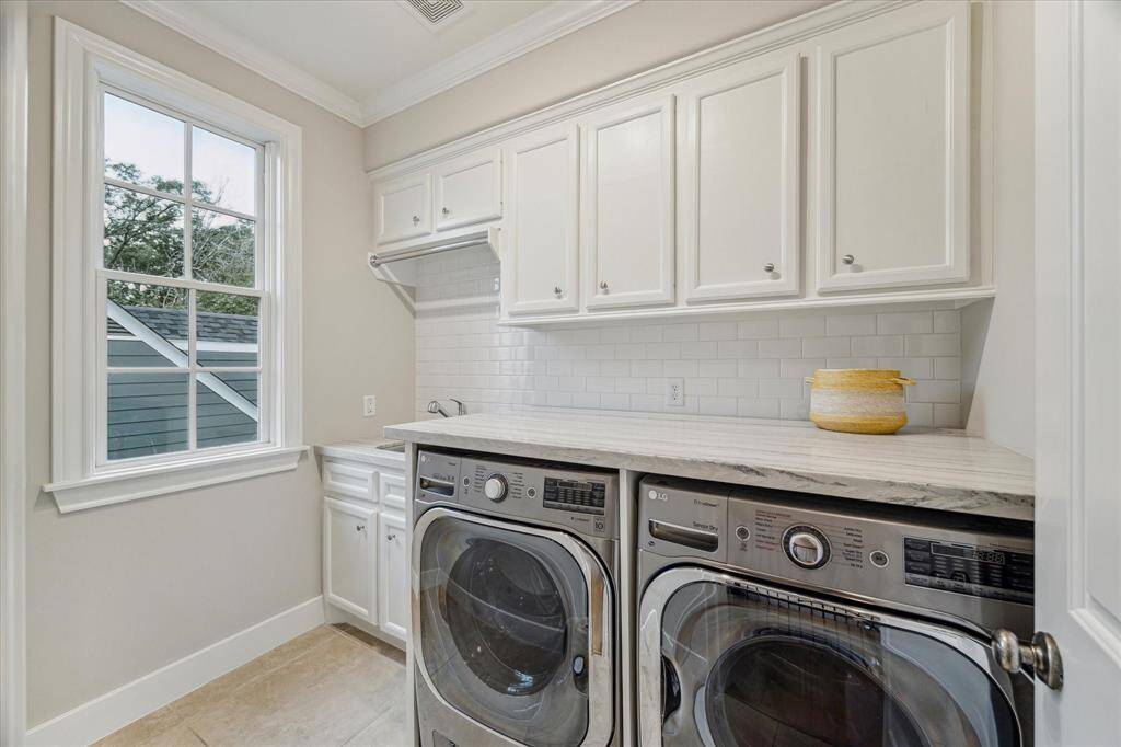 LAUNDRY.   The laundry was re designed to accommodate a larger washer and dryer.  A quartzite counter top was added for folding clothes.