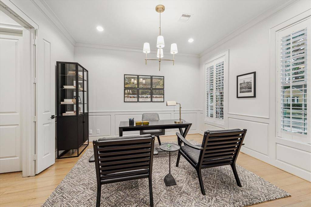 STUDY. Located at the front of the home with pretty views out over the front lawn, the study is a generous space. Note the wainscoting. Chandelier - Circa lighting by Thomas O Brien.