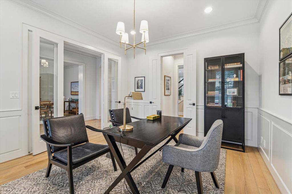 Another view of the study showing the double glass doors to the entrance hallway and the door through to the powder room and back of the home.