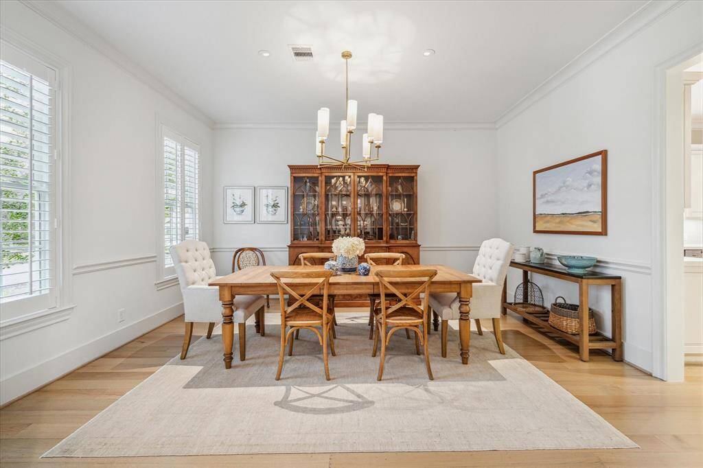 DINING.   This impressive room sits across from the study off the main front entry.   Note the art rail detail.  Chandelier - Circa lighting by Thomas O Brien.