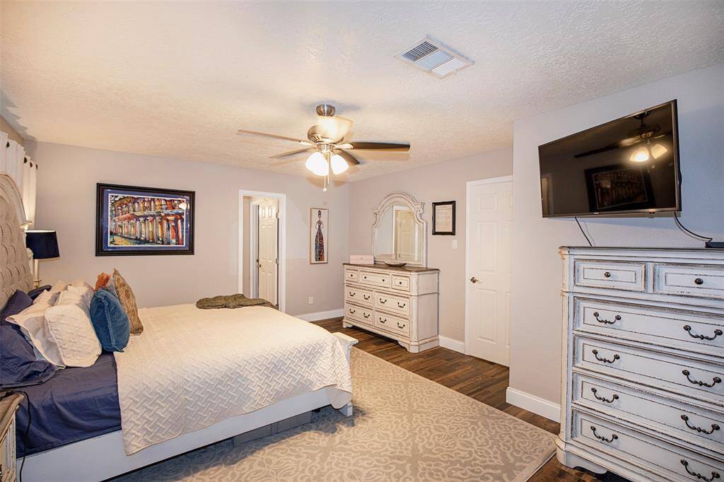 One of the larger bedrooms this room includes a walk-in closet and ceiling fan with lights.