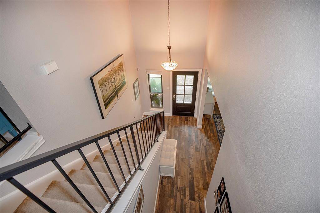 A cozy room ideal for gaming or a small office, featuring a ceiling fan, carpeted floor, and neutral walls. This versatile space includes a closet with double doors and ample storage space for relaxation or work.