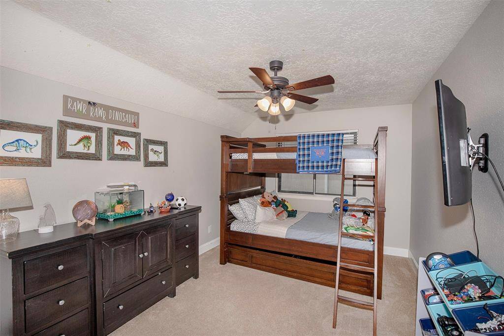 This backyard features a well-maintained lawn and hot tub which is included in the sale. Enclosed with a wooden fence providing additional privacy it is a great area for relaxation.