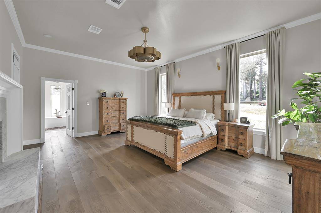 This king-sized primary suite is both beautiful and functional.