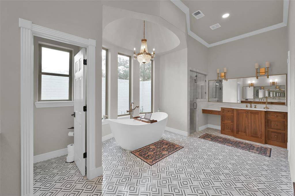 One final view of the primary bathroom showing separate vanities.