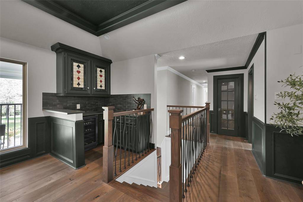At the top of the stairs is a bar/beverage area serving the large gameroom and expansive patio overlooking the estate.
