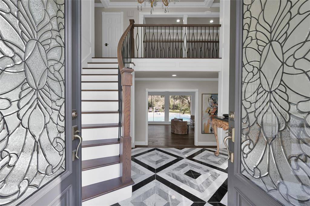 Designer flooring and custom paint make a great first impression in the formal entry.