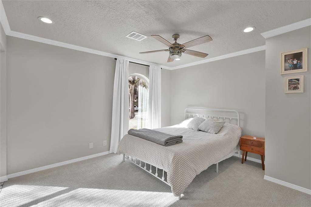 Another view of bedroom #4 with ceiling fan and crown molding.