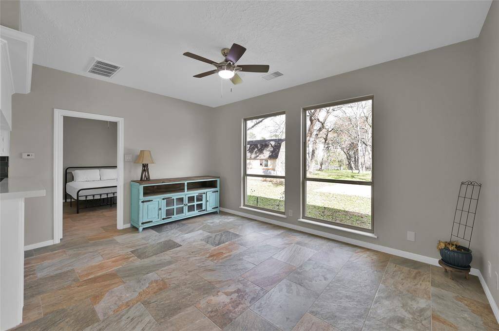 The large guest house is completely renovated to include a full kitchen, bedroom, bathroom, and a living area.